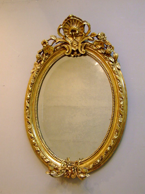 antique oval mirror with candle scones